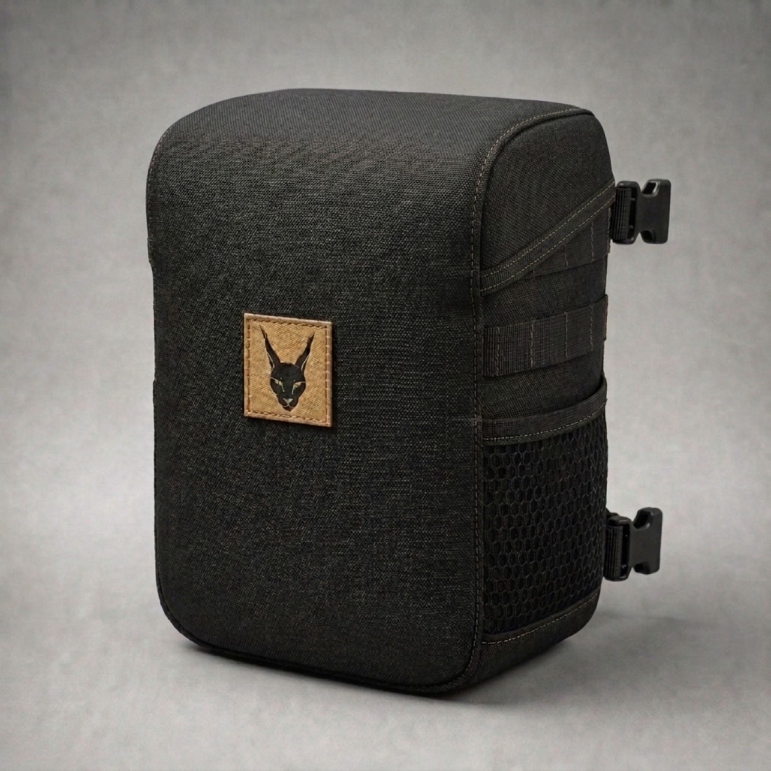 WESHQ curved harness bag in charcoal canvas with the caracal patch, studio render